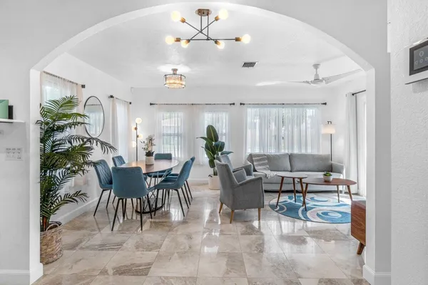 a living room with furniture and a potted plant