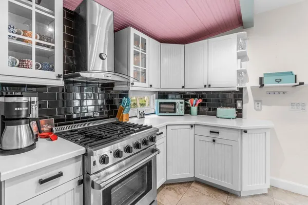 a bathroom with a tub a sink and a mirror
