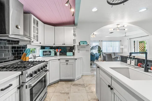 a bathroom with a bathtub a mirror a sink and vanity