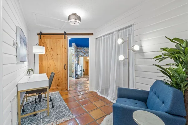 a view of patio with chairs and table under an umbrella