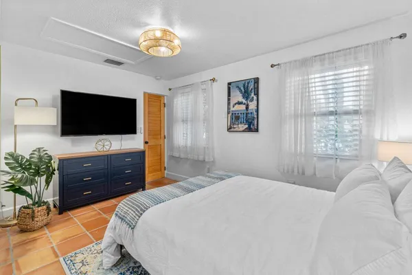 a view of a patio with table and chairs under an umbrella