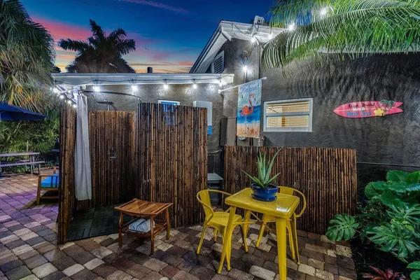 a view of a white house with a yard and plants