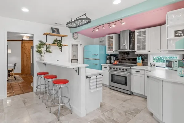 a view of a backyard with a patio and swimming pool