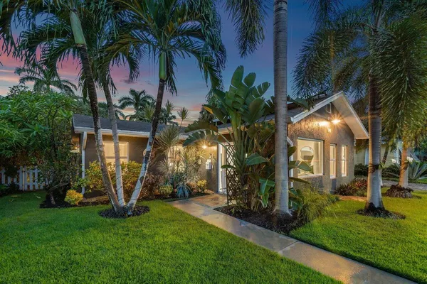 a view of a house with a flower garden