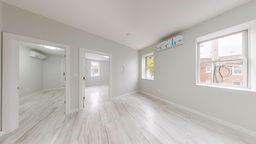 7902 16th Avenue Brooklyn, NY 11214 - Photo 11 of 17 a view of an empty room with wooden floor and a window