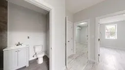 a bathroom with a toilet sink and a mirror
