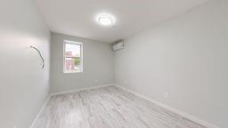 7902 16th Avenue Brooklyn, NY 11214 - Photo 14 of 17 an empty room with a window