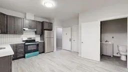 a kitchen with stainless steel appliances granite countertop a refrigerator stove and sink