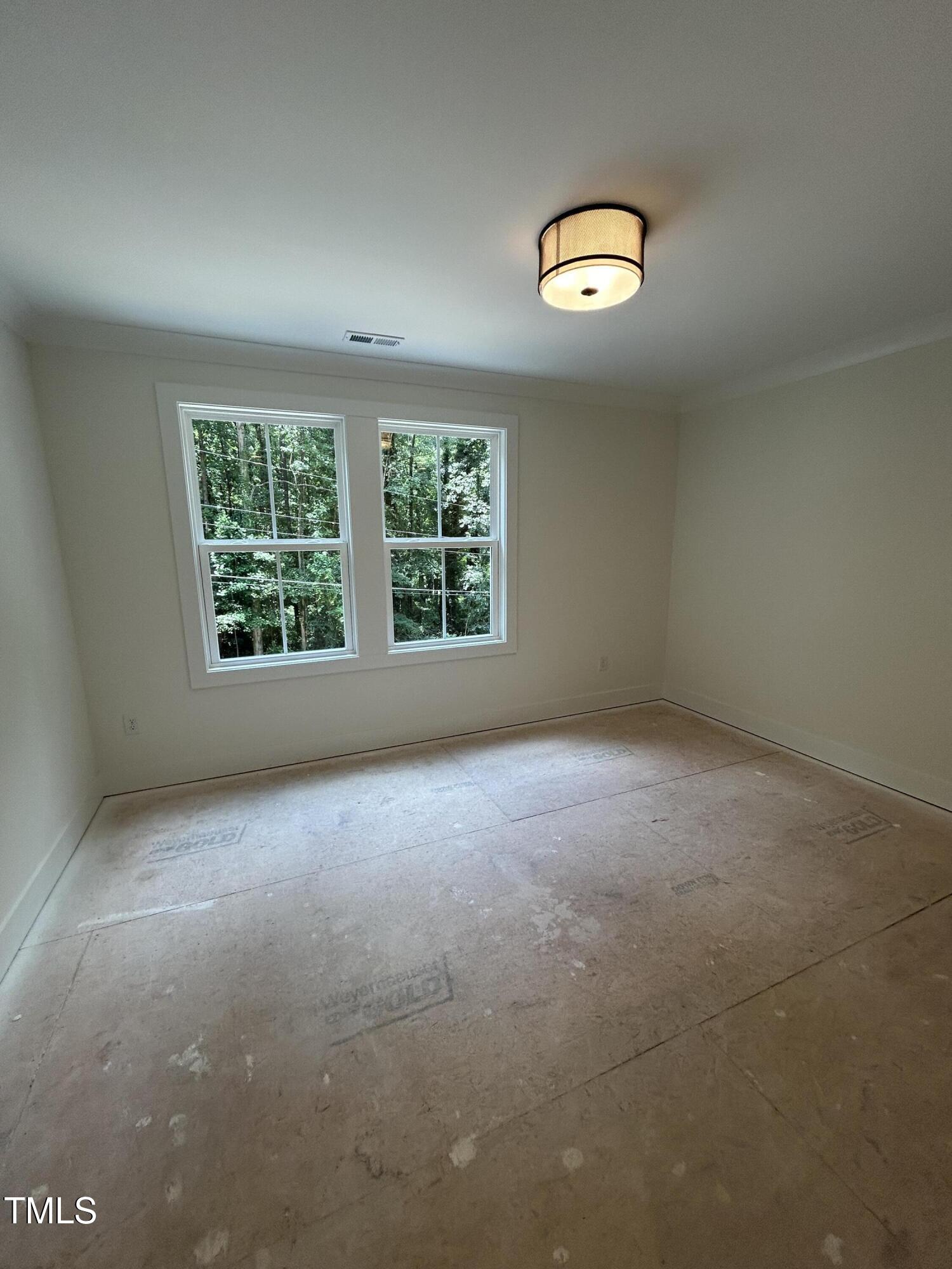 701 Locust Lane Raleigh, NC 27603 - Photo 13 of 19 an empty room with windows