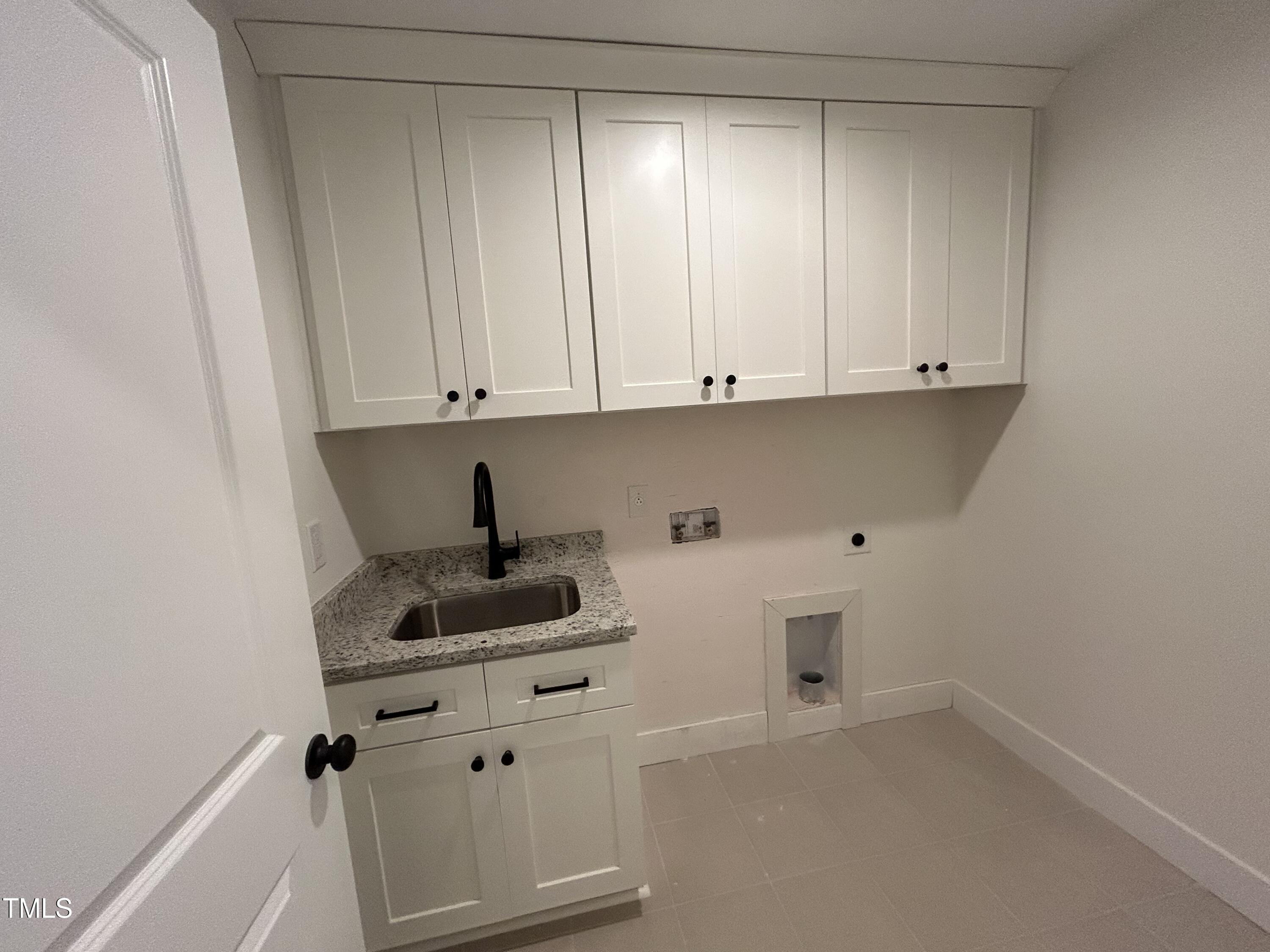 701 Locust Lane Raleigh, NC 27603 - Photo 14 of 19 a kitchen with white cabinets and a sink