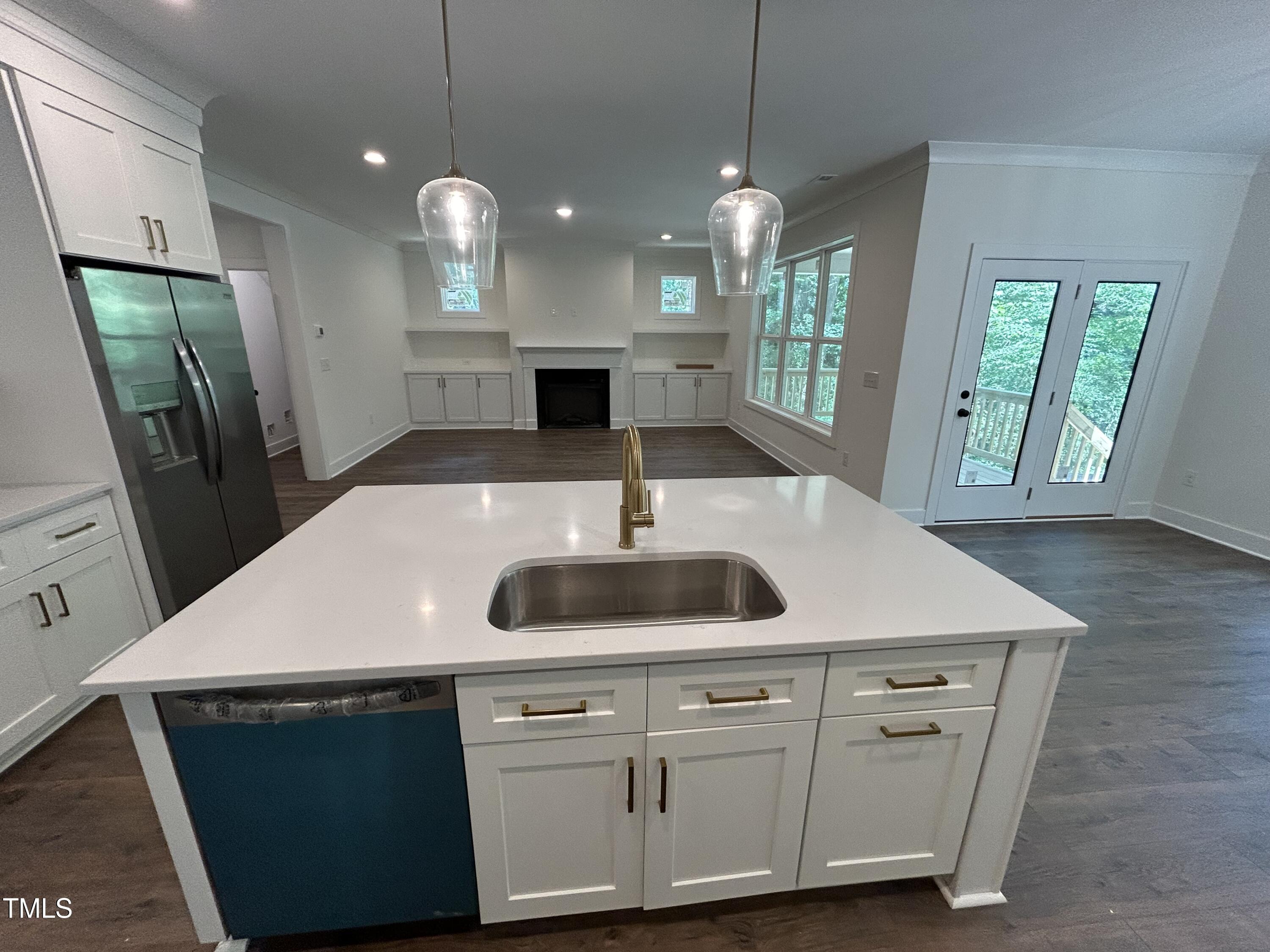 701 Locust Lane Raleigh, NC 27603 - Photo 6 of 19 a kitchen with a sink a counter space and a refrigerator