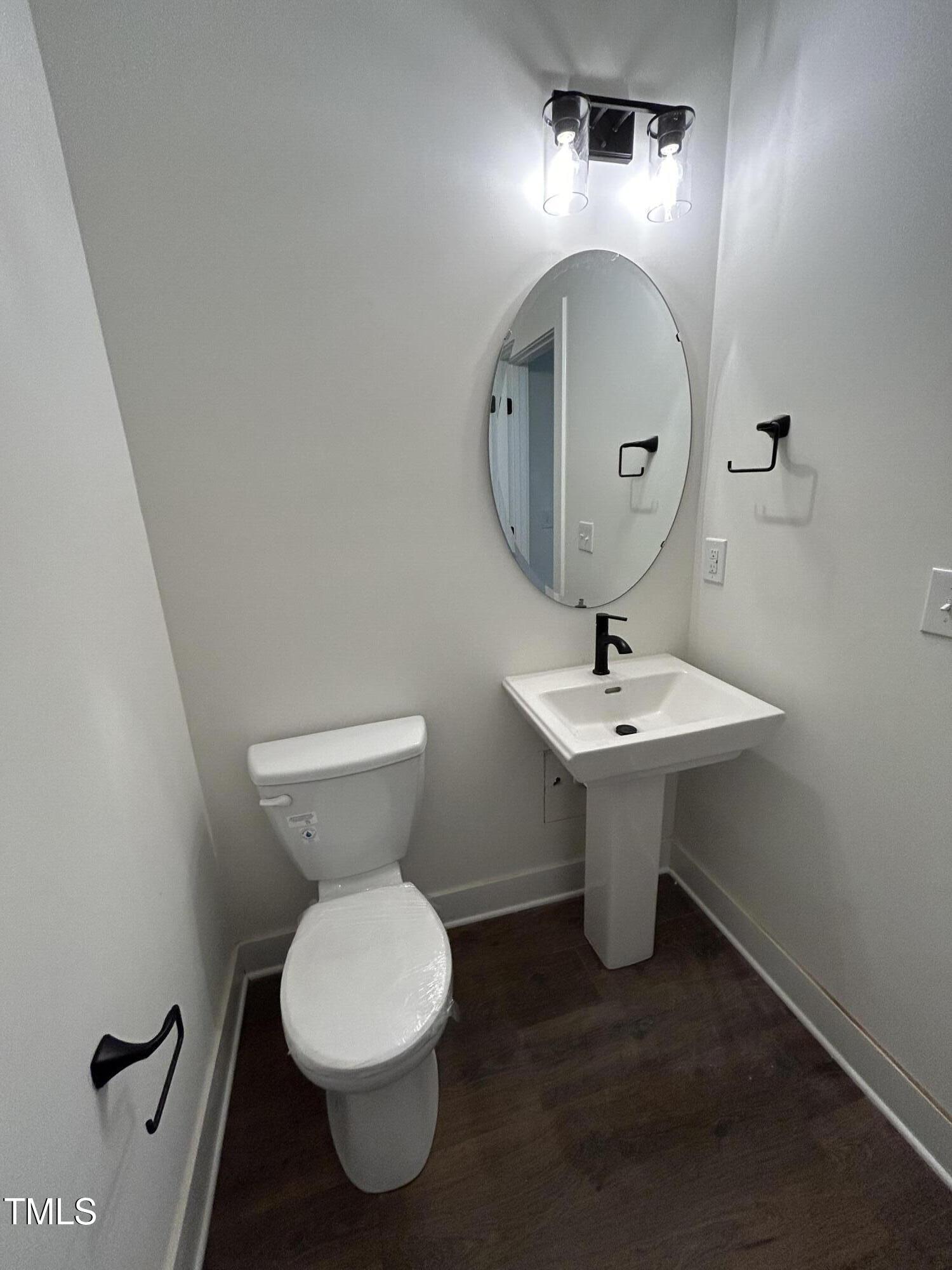 701 Locust Lane Raleigh, NC 27603 - Photo 7 of 19 a bathroom with a toilet sink and mirror