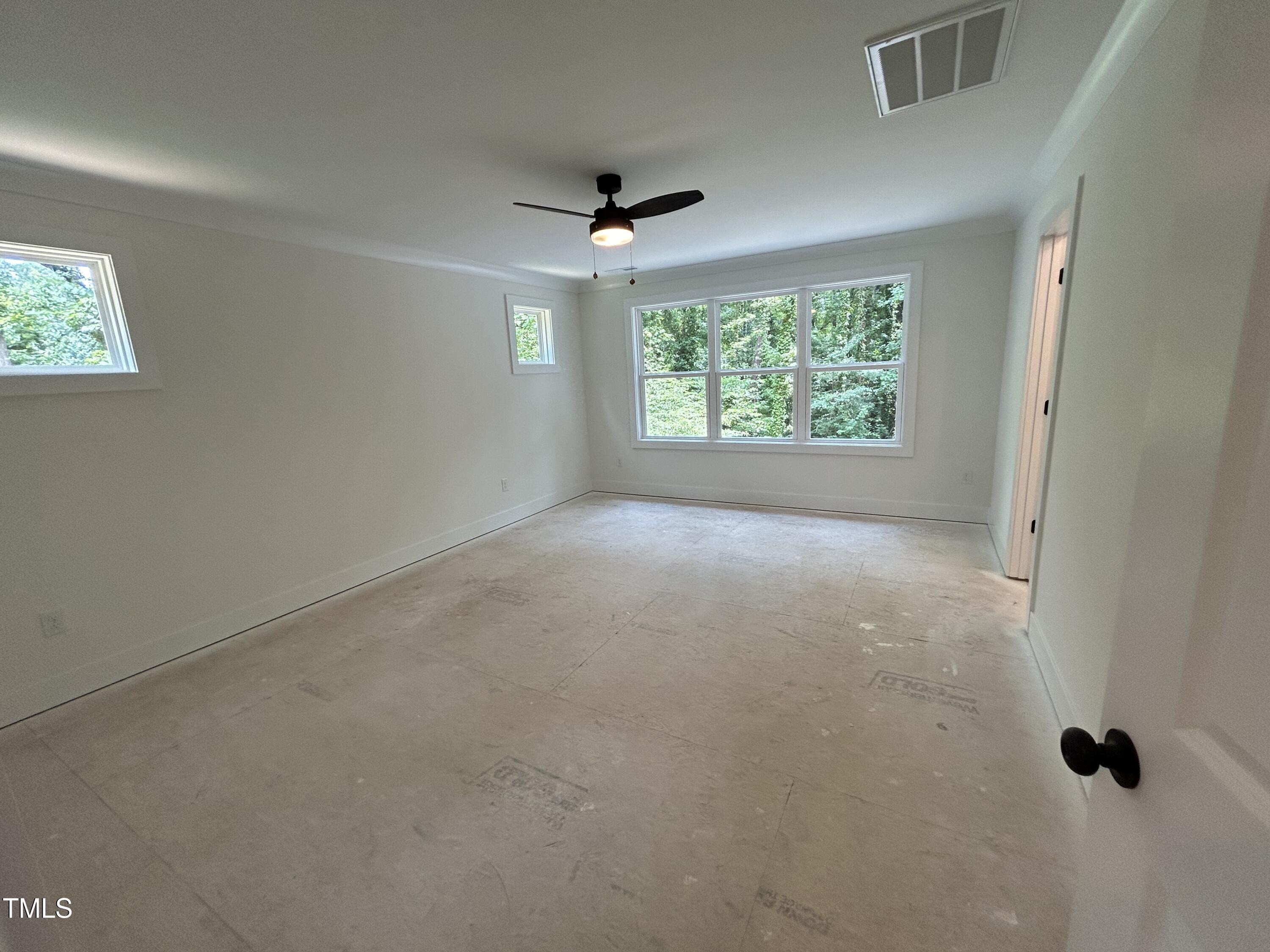 701 Locust Lane Raleigh, NC 27603 - Photo 8 of 19 a view of an empty room with a window
