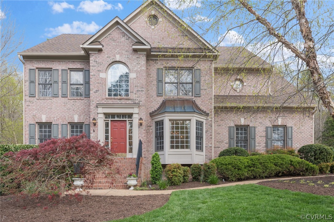 a view of a white house next to a yard