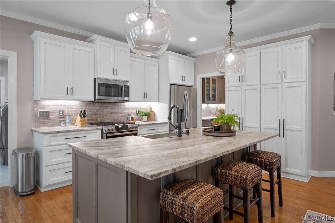 2713 Founders Bridge Road Midlothian, VA 23113 - Photo 14 of 49 a kitchen with stainless steel appliances granite countertop a stove refrigerator a sink a dining table and chairs with wooden floor