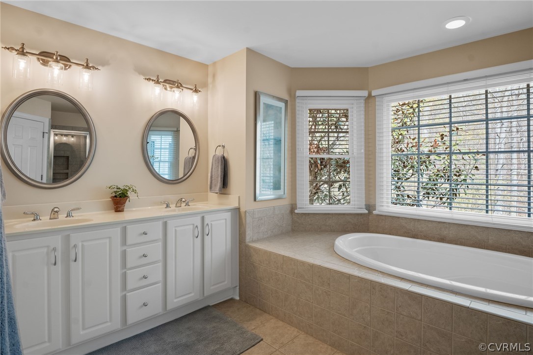 2713 Founders Bridge Road Midlothian, VA 23113 - Photo 25 of 49 a bathroom with a granite countertop sink a mirror and bathtub