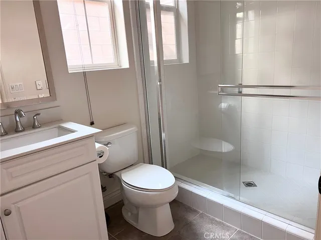 a bathroom with a toilet sink and a shower