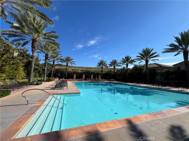 a view of a swimming pool with lounge chairs