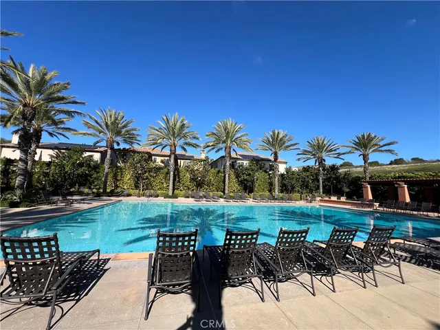 a view of a swimming pool and chairs