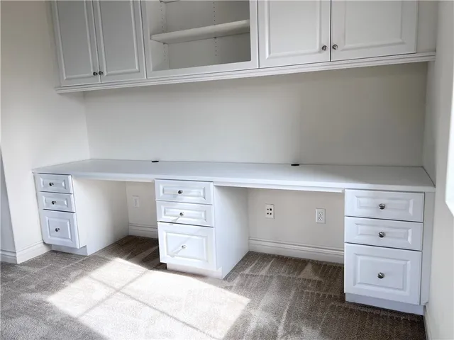 a room with cabinets and white cabinets