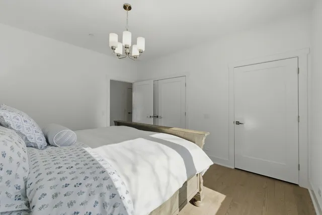 a bedroom with a large bed and a window