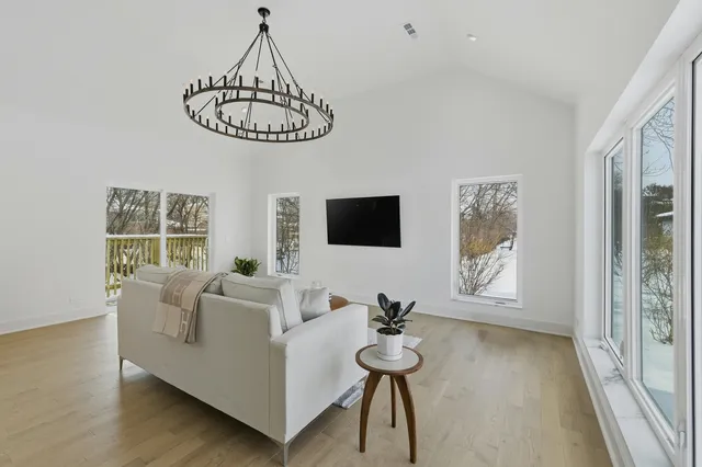 a living room with furniture a window and a flat screen tv