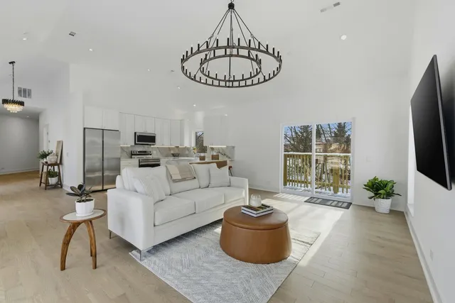 a living room with furniture a window and a flat screen tv