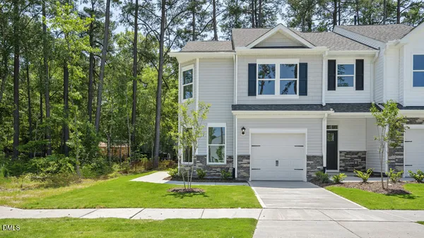 a front view of a house with a yard