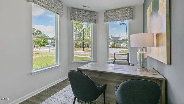 a dining room with furniture and a window