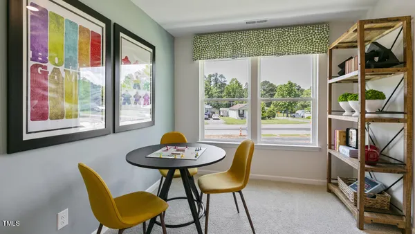 a view of a dining room with furniture a rug and wooden floor