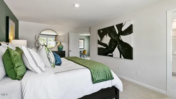 a bedroom with a bed closet and mirror