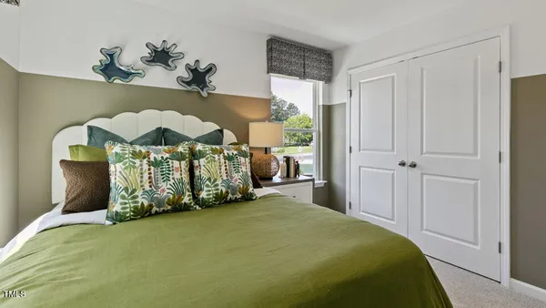 a bedroom with bed and window