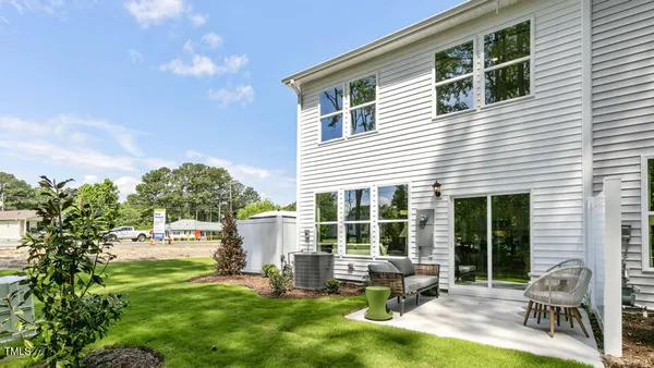 a house view with a sitting space and garden
