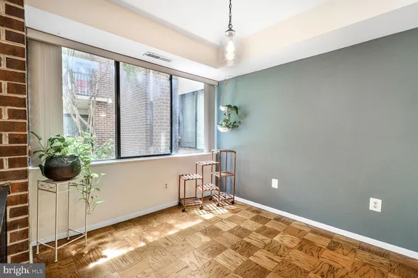 a view of a room with window and wooden floor