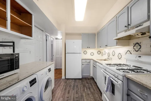 a kitchen with stainless steel appliances granite countertop a stove and a refrigerator