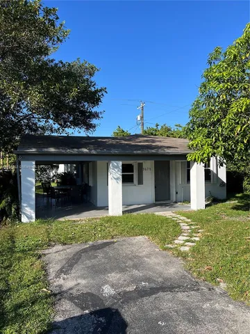 a view of a house with a yard and garage