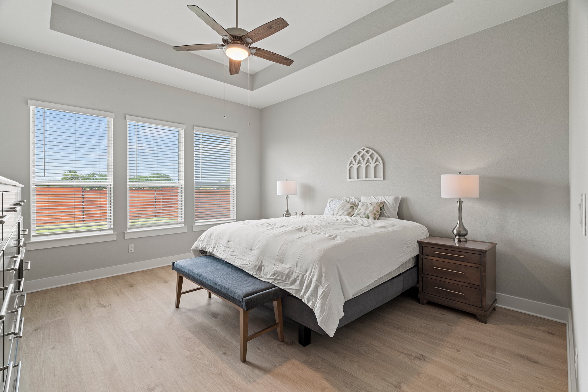2112 Tobiano Trace Georgetown, TX 78633 - Photo 15 of 40 Bedroom with a raised ceiling, light wood-style floors, and ceiling fan