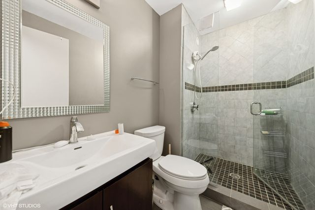a bathroom with a sink toilet and shower