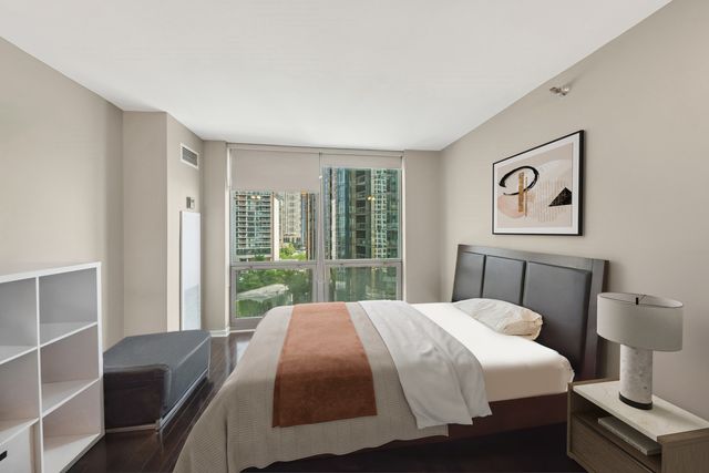 a bedroom with a bed and glass window