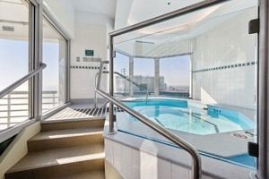 a view of swimming pool with furniture and window