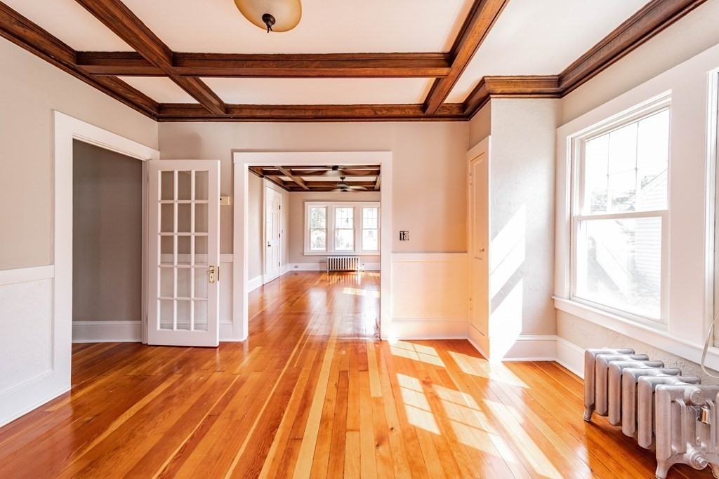 120 Winton Street Springfield, MA 01118 - Photo 4 of 25 a view of an empty room with wooden floor and windows