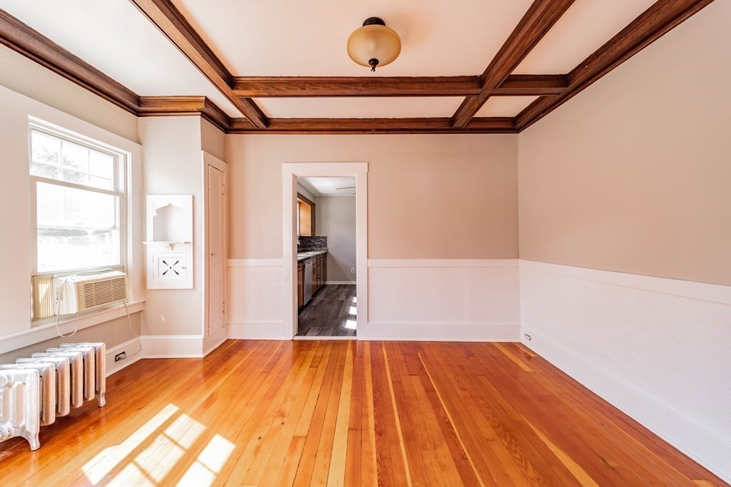 120 Winton Street Springfield, MA 01118 - Photo 6 of 25 a bedroom with a bed and wooden floor