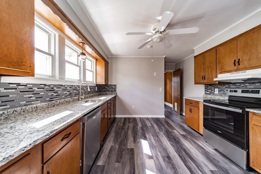120 Winton Street Springfield, MA 01118 - Photo 7 of 25 a kitchen with stainless steel appliances granite countertop a stove and a sink