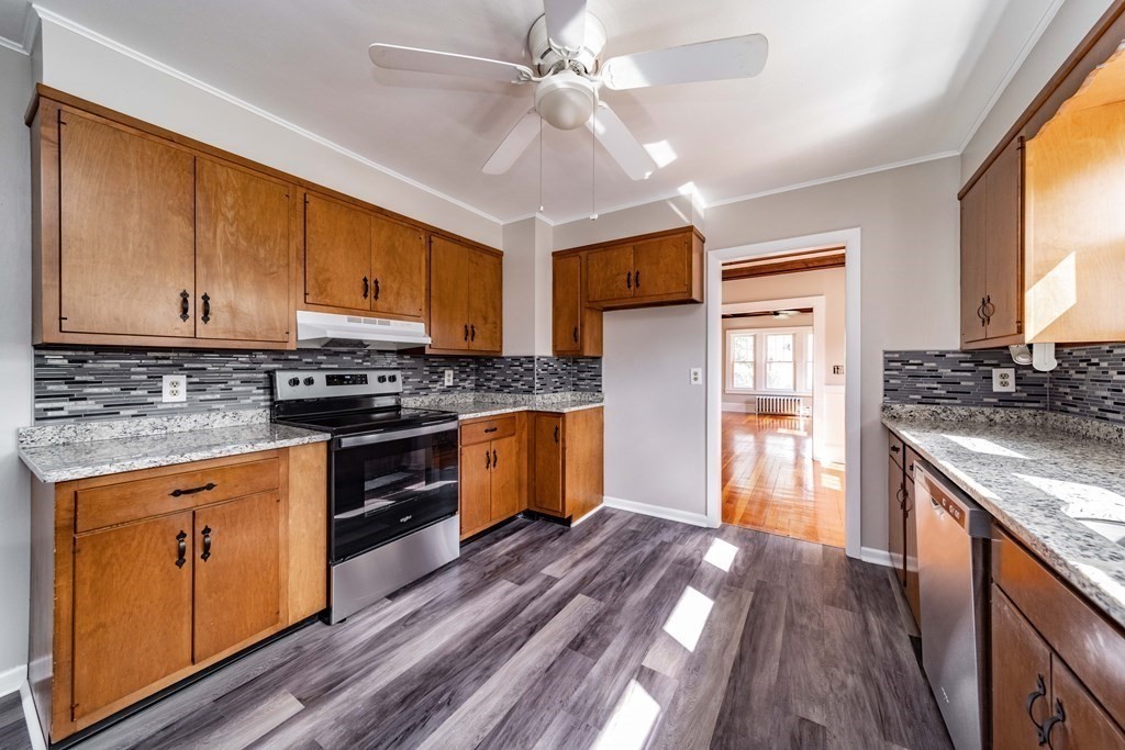 120 Winton Street Springfield, MA 01118 - Photo 8 of 25 a kitchen with stainless steel appliances granite countertop a stove a sink dishwasher and a refrigerator
