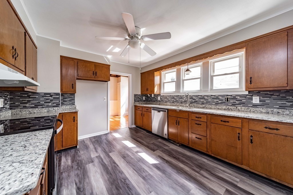 120 Winton Street Springfield, MA 01118 - Photo 9 of 25 a kitchen with stainless steel appliances granite countertop a stove a sink and a refrigerator