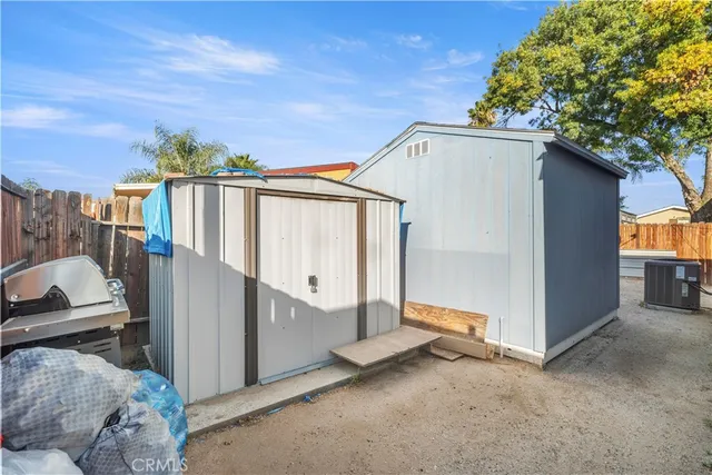 a view of backyard with cabin and wooden fencing