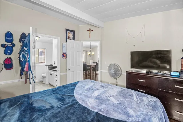 a bedroom with furniture and flat screen tv