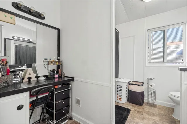 a bathroom with a toilet a sink and a mirror