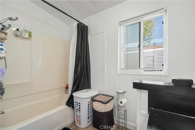 a bathroom with a granite countertop toilet sink and mirror