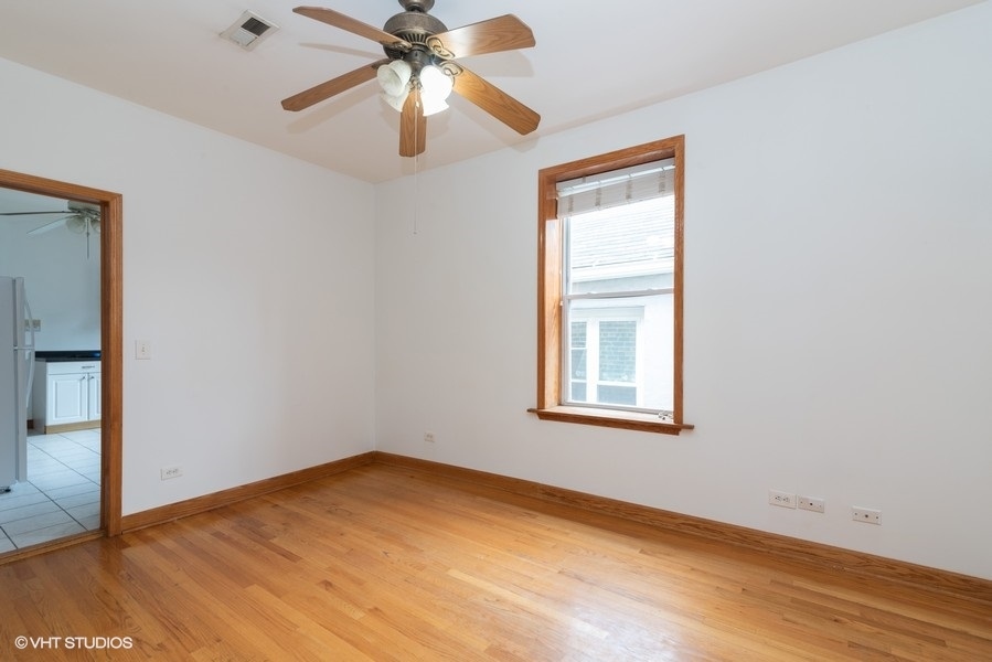 819 South Carpenter Street, Unit 3R Chicago, IL 60607 - Photo 4 of 10 an empty room with a window and a fan